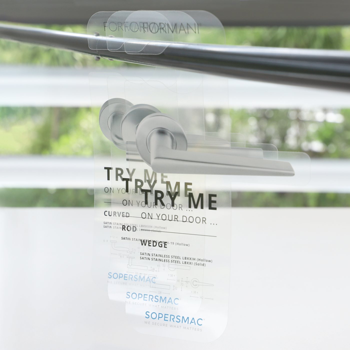 A stack of Sopersmac clear door hangers